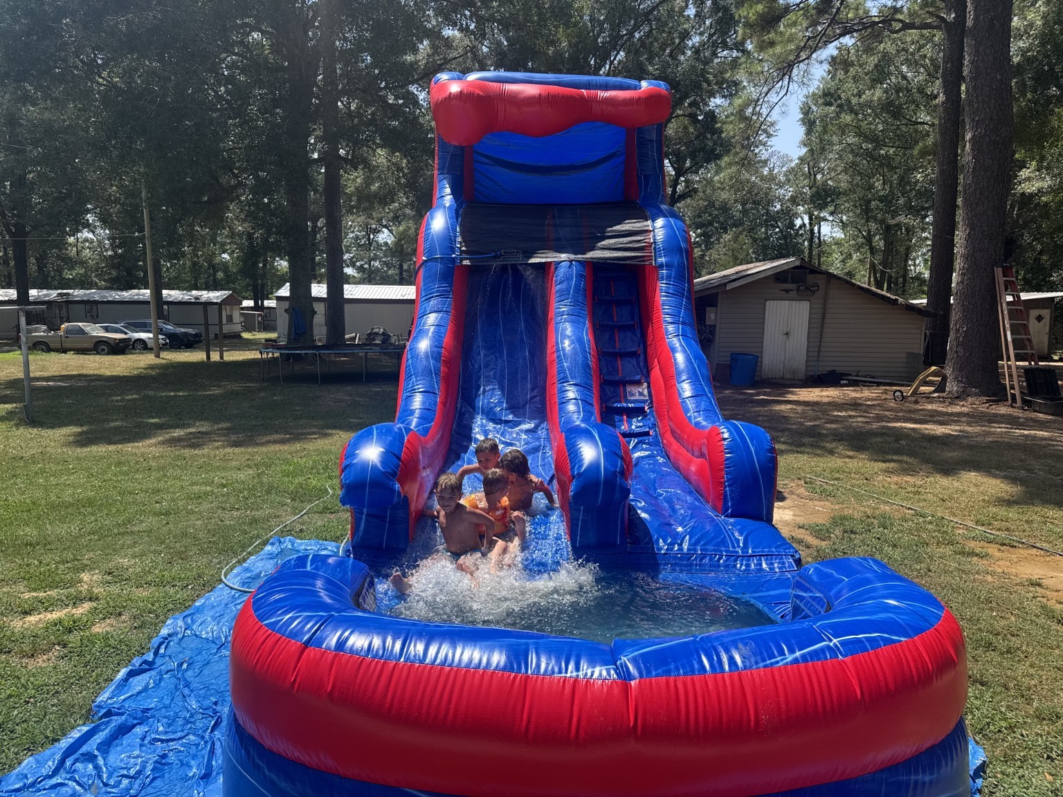 Red and blue inflatable water slide in use